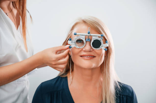 istock Wearing glasses. Woman's vision is tested by clinic worker that using special device 1436162873