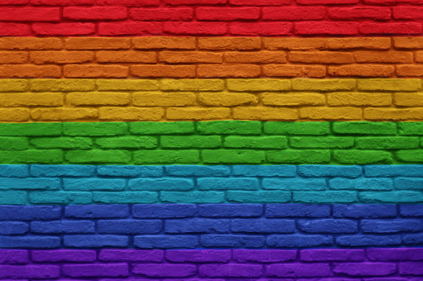 istock Urban brick wall with peace rainbow flag colors  painted. 1436163414