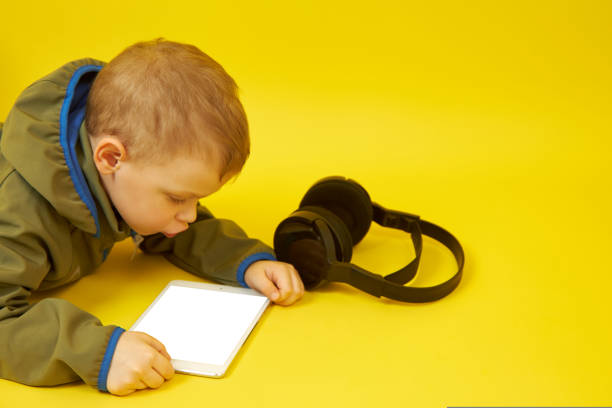 istock Children and modern technologies on a yellow background 1436164504