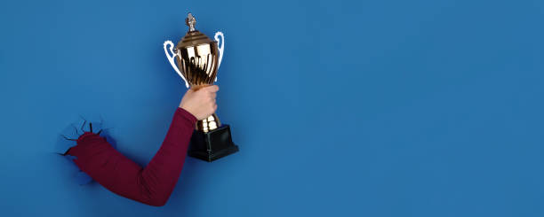 istock sports cup in hand panoramic 1436164839