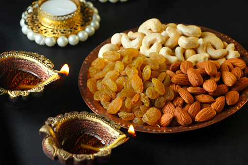Dry fruits with beautiful festival background, Diwali lamp. Diwali festival Background