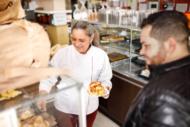 istock Customer being served by the bakery's owner 1436167338