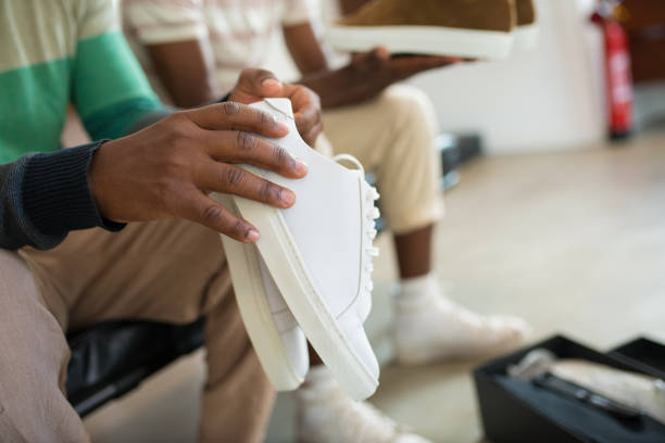 close-up of african american mans hands with shoes - adult variation boutique occupation imagens e fotografias de stock