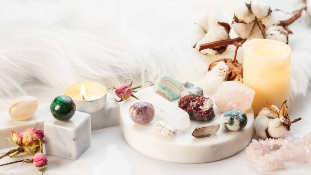 Healing Stones for Crystal Spiritual Wicca Ritual Minerals Collection on White Marble Stand with Burning Candles and Dry Flowers. Healing Stones for Wicca Witchcraft Practice. Copy Space for Text crystal altar stock pictures, royalty-free photos & images