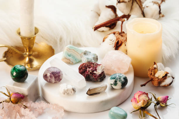 Healing Stones for Crystal Spiritual Wicca Ritual Minerals Collection on White Marble Stand with Burning Candles and Dry Flowers. Healing Stones for Wicca Witchcraft Practice on White Marble Stand crystal altar stock pictures, royalty-free photos & images