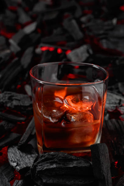 istock Whiskey with ice  on a background of burning charcoal. 1436168518