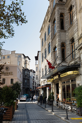 Istanbul,Turkey- October 24,2022:Karaköy District In Istanbul City.Turkish people walking in the street.Karaköy is a district of Istanbul's Beyoğlu district. It is one of the oldest commercial centers, famous for its banks and office buildings. It is the modern name of the old Galata district. It has come to the forefront as a port and trade center throughout history. Today, it is an important trade and transportation center.