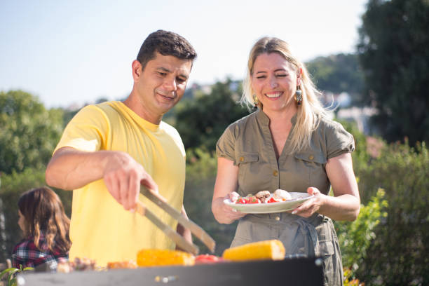 istock Caring husband and wife making BBQ in backyard 1436171531