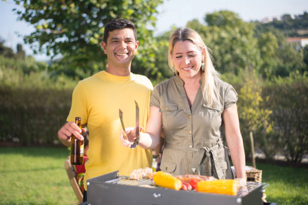 istock Happy husband and wife making BBQ in backyard 1436171603