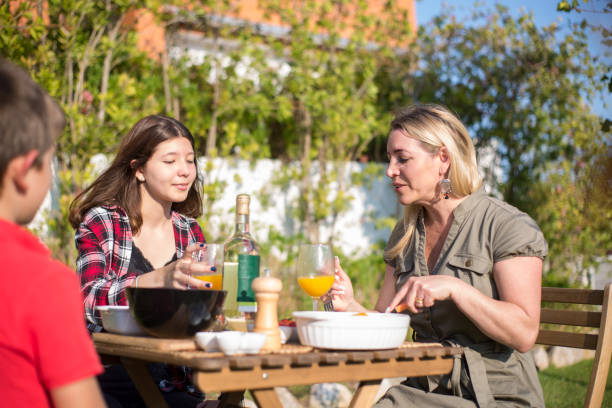 istock Happy mother and children eating BBQ at backyard 1436171606