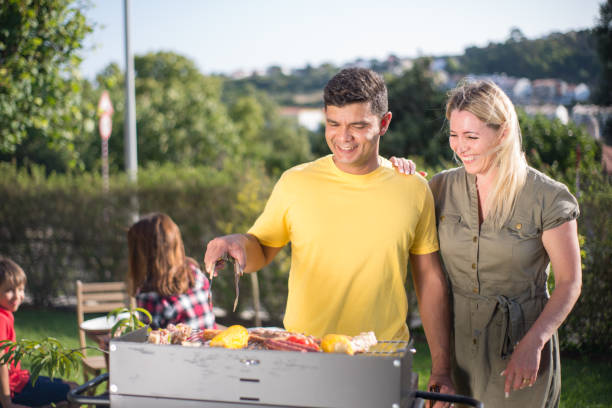 istock Loving husband and wife making BBQ in backyard 1436171629
