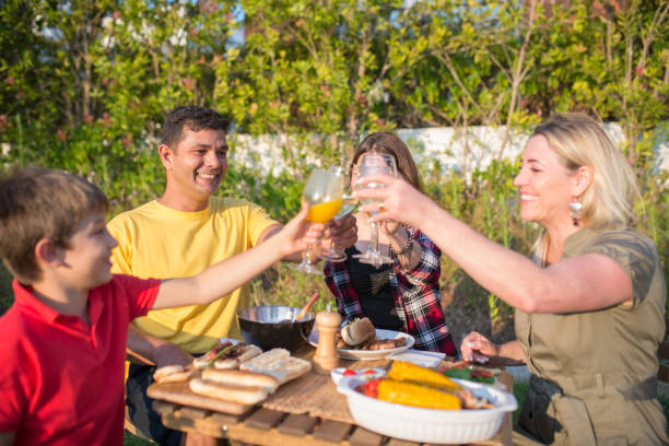 istock Delighted family clinking glasses at backyard 1436171697