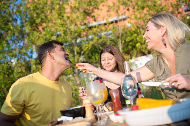 istock Joyful family eating BBQ at backyard 1436171709