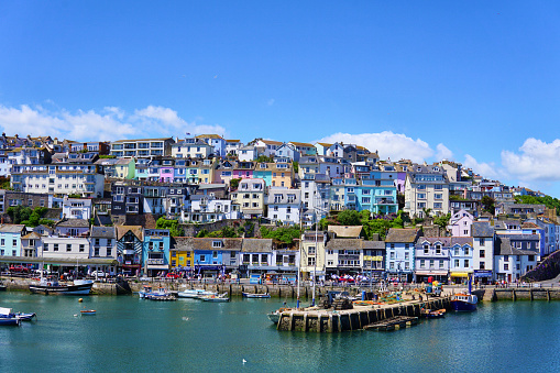 Colorful buildings and fishing boats in town of Brixham on the south coast of Devon, summer holiday destination.