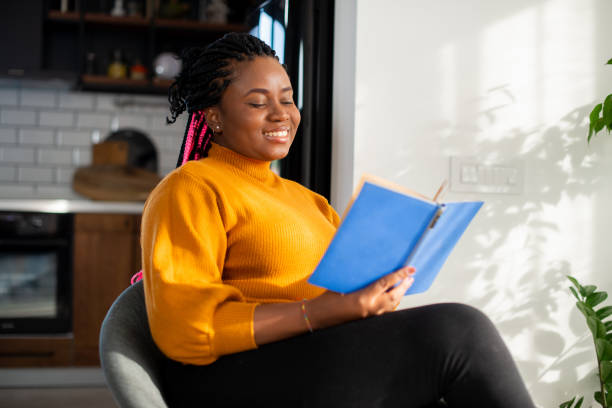 istock Woman relaxing and reading a book 1436175996