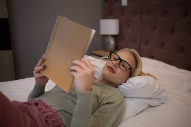 istock Woman relaxing and reading a book 1436176033