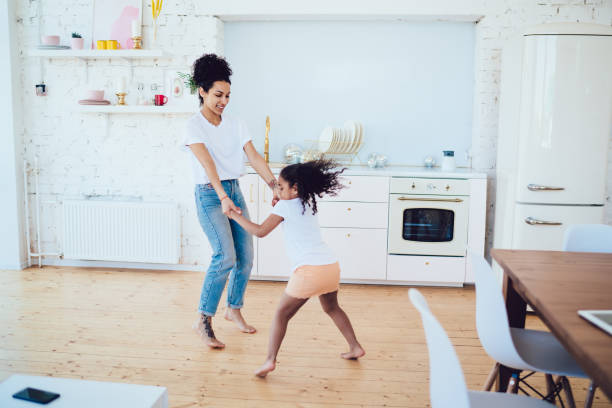 istock Daughter and mother having fun on bright kitchen 1436176266
