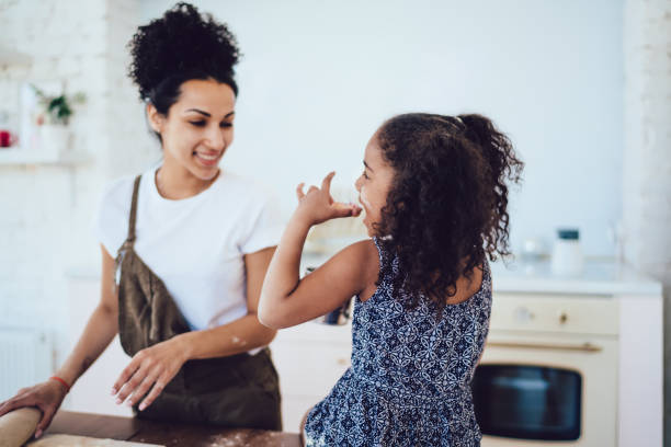 istock Girl eating homemade cookie in kitchen 1436176272