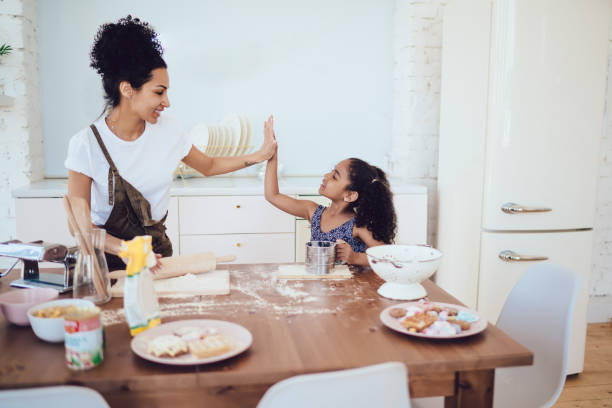 istock Mother and child giving high five during cooking 1436176273