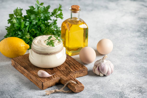 istock Aioli sauce with ingredients on a concrete background. Side view, selective focus, copy space. Homemade mayonnaise. 1436176903