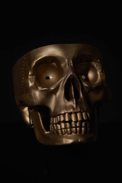 istock Gold human Skull Isolated on black background 1436180308