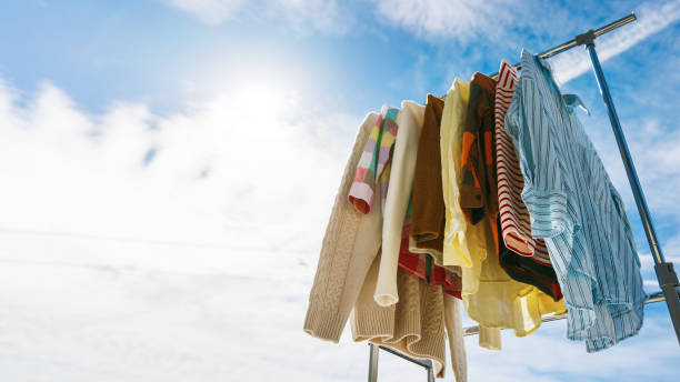 istock Clothes hanging on rail against blue sky. 1436180939
