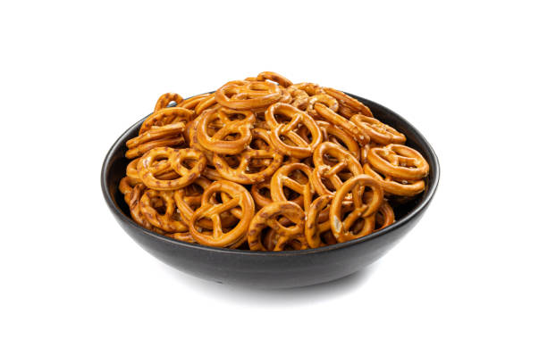 Pretzel Cookies Isolated, Small Salted Pretzels, Crispy German Brezel Snack Pretzel Cookies in Black Bowl Isolated. Small Salted Pretzels, Crispy Beer Snack, German Brezel, Beer Fest Symbol, Crusty Knot Shaped Pretzel Cookie on White Background pretzel stock pictures, royalty-free photos & images