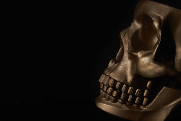 istock Gold human Skull Isolated on black background 1436181149