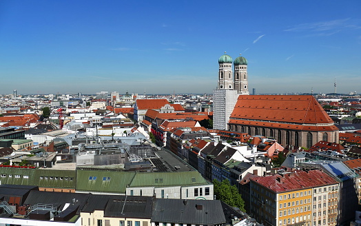 Panoramic view over Munich from the Alter Peter’s tower of the Church of St. Peter between Marienplatz and Rindermarkt. The Cathedral of Our Dear Lady (Frauenkirche ) is under restoration work. At the background you can see the silhouette of the olympic TV tower.Panoramic view to the pedestrian zone. At the right you can see he Cathedral of Our Dear Lady (Frauenkirche ).