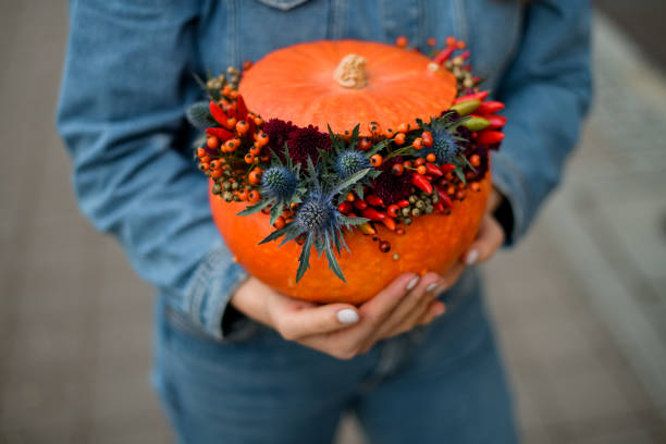istock beautiful orange pumpkin with thistle, red pepper, berries and chrysanthemums. Decor for thanksgiving and halloween. 1436181350
