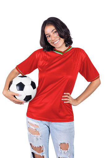 Young soccer fanatic woman with Wales red sports jersey and ball in his hands, happy for the victory of his favorite team.