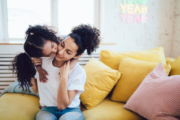 istock Tender mother and daughter bonding on sofa in flat 1436182430