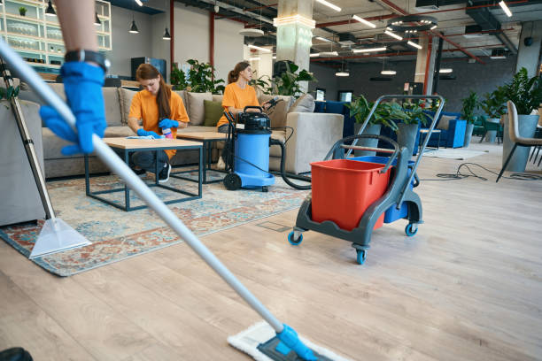 istock Cleaning in the coworking area, workers use a vacuum cleaner 1436184015