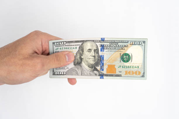 istock Hand, money US dollars, close-up on a white background 1436185692