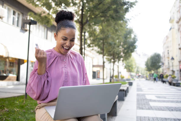 istock Cheerful  woman doing online shopping 1436185786