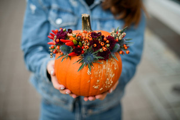 istock wonderful orange pumpkin with thistle, red pepper, berries and chrysanthemums. Decor for thanksgiving and halloween. 1436186732