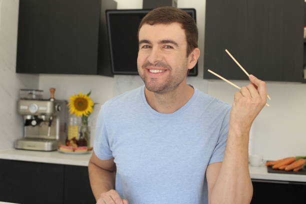 istock Man ready to eat with pair of chopsticks 1436188523