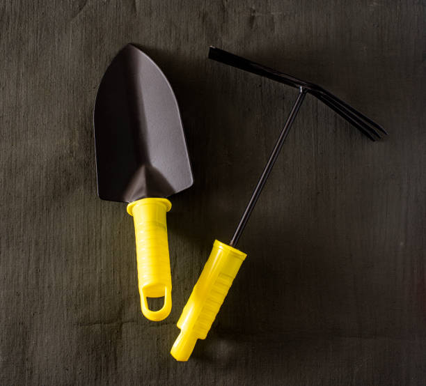 istock garden tools shovel and rake on a dark tarpaulin. 1436188537