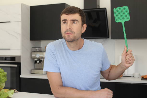 istock Man trying to catch a fly 1436189476