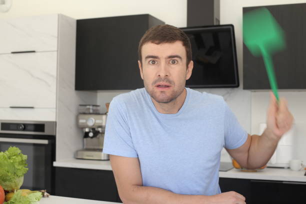 istock Man trying to catch a fly 1436189536