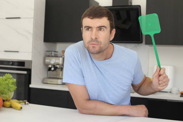 Man trying to catch a fly