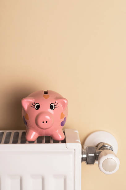 istock Piggy bank  sits on a radiator 1436190192
