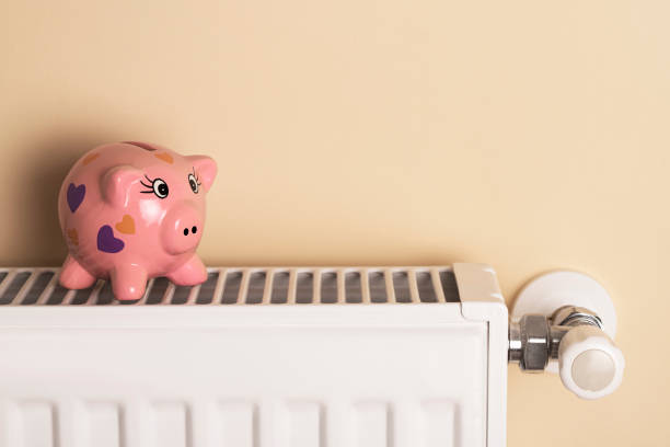 istock Piggy bank  sits on a radiator 1436190257