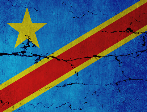 Congolese Flag on cracked wall background.