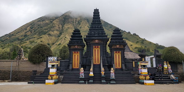 The Poten Temple (Pura Luhur Poten) is a holy temple for the Tenggernese people. Mount Batok can be seen in the background. It is located in the middle of the plain called Laut Pasir near the foot