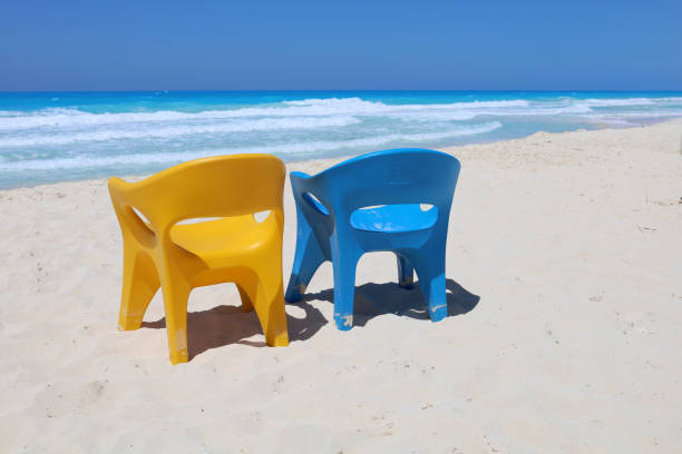 Blue and yellow chair at sea beach stock photo