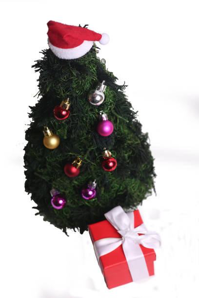 istock decorated fake fir tree and a present box isolated on white background flat lay 1436194592