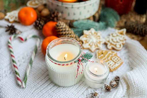 Red candles and baubles on white background. This File is cleaned, retouched and contains 