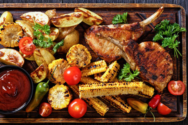 istock bbq tomahawk pork chop with corn and potatoes 1436196136