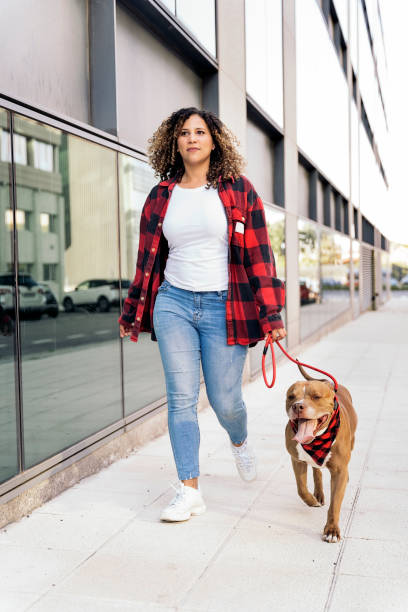 istock Young Woman Walking her Dog 1436198394